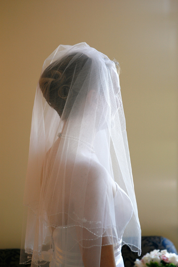 photo by New York based wedding photographer Merri Cry - side portrait of the beautiful bride wearing a full length veil